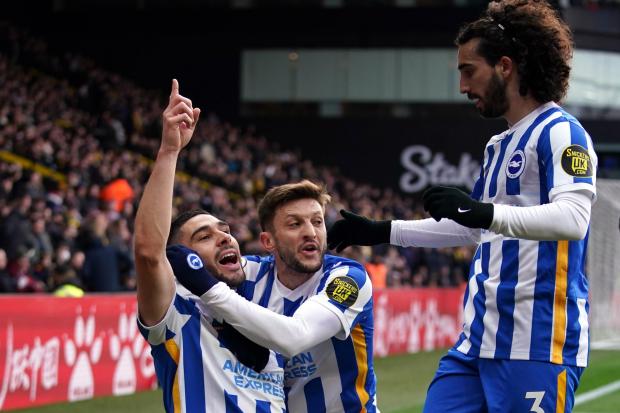 Brighton and Hove Albion's Neal Maupay celebrates scoring the opening goal with Adam Lallana and Marc Cucurella (right) during the Premier League match at Vicarage Road, Watford. Picture date: Saturday February 12, 2022.
