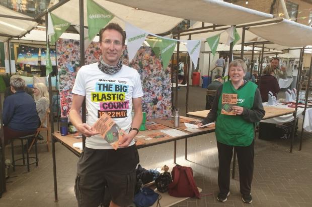 The Argus: Greenpeace volunteers Gildas Ehrmann (left) and Anne Massey in The Old Market, Brighton, with the six month plastic waste image. Photo: Greenpeace
