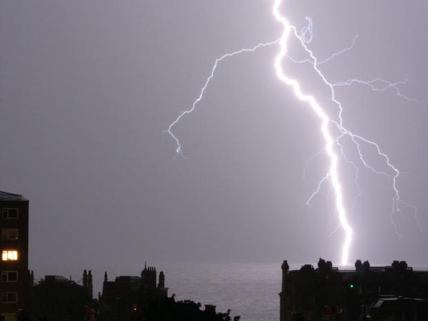 The Argus: Picture in our camera club by Nick Ryder of a lightning strike near Rampion Wind Farm last night
