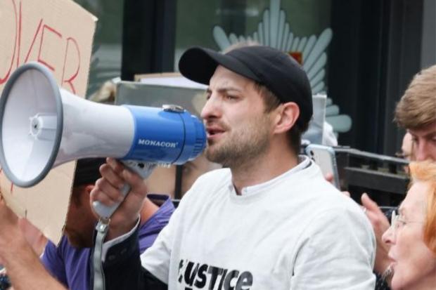 The Argus: Karl Holscher-Ermet at a protest outside of Sussex Police HQ earlier this month 