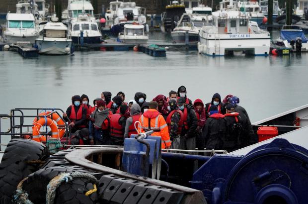 The Argus: A group of people thought to be migrants are brought in to Dover, Kent, onboard a Border Force vessel, following a small boat incident in the Channel
