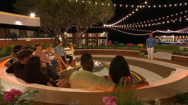 The Argus: The Islanders gather at the fire pit for Davide's decision on Love Island, tonight at 9pm on ITV2 and ITV Hub. Episodes are available the following morning on BritBox. Credit: ITV