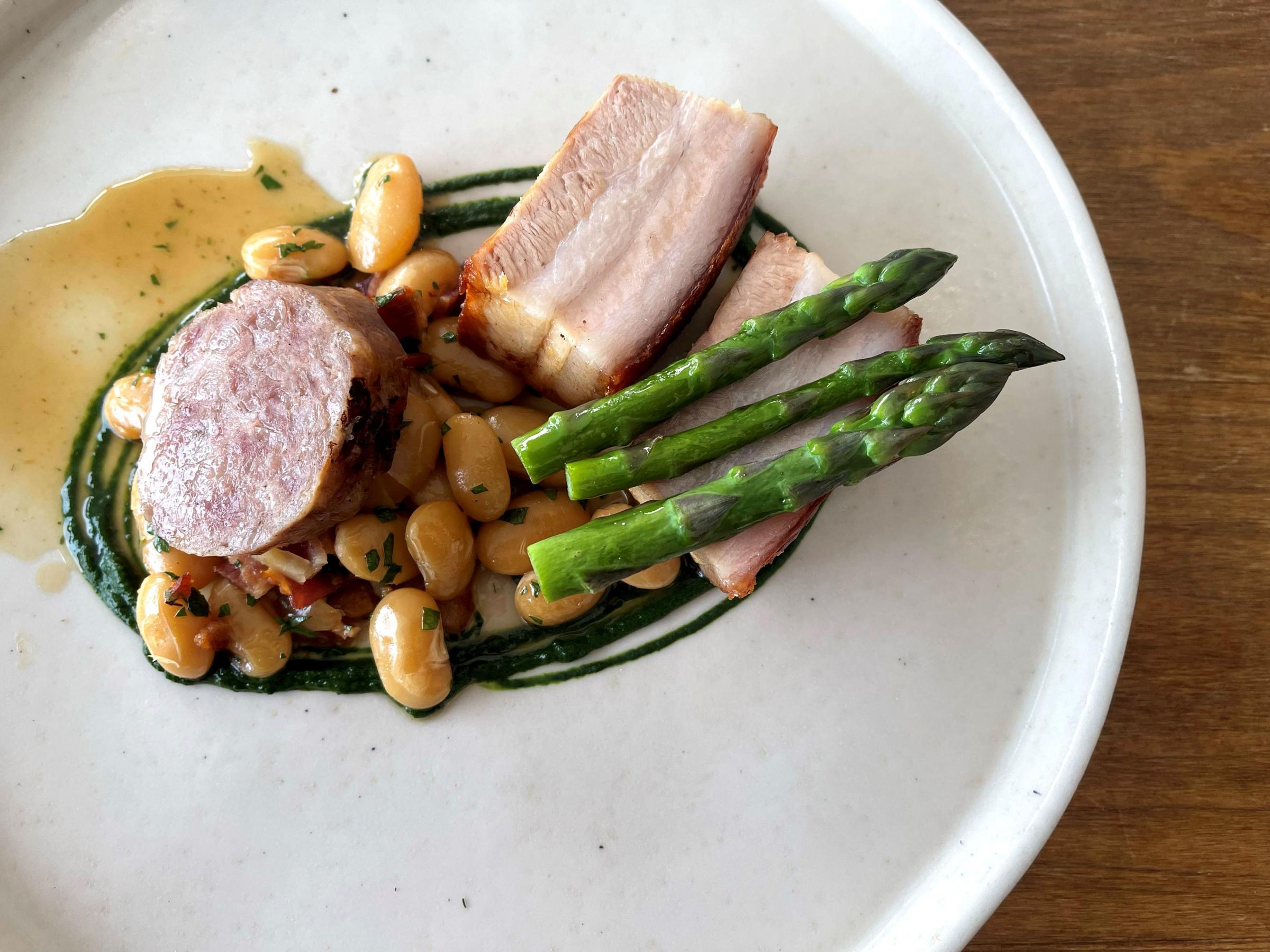 Pork belly, smoked bacon and sausage with asparagus and butter bean ragout