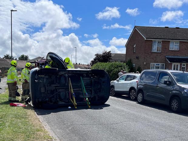 The Argus: Police and firefighters attended the overturned car in Eastbourne