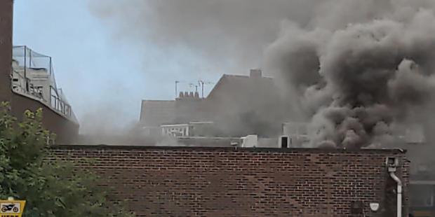 The Argus: clouds of smoke from the shop roof. Image by Carl Lee