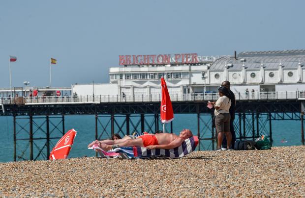 The Argus: A man relaxes on Brighton beach. Photo: Simon Dack