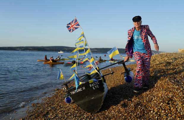 The Argus: Michael Stanley, known as'Major Mick', readies his boat as he prepares to row his boat Tintanic II across the Solent from Hurst Castle towards the Isle of Wight as part of his Tintanic Charity Challenge. Photo: PA