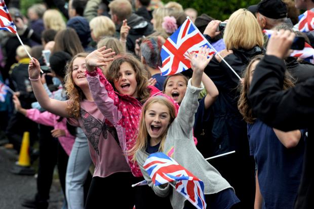 The Argus: Children cheered and waved flags as the Olympic torch approached in Lancing: credit - Liz Finlayson