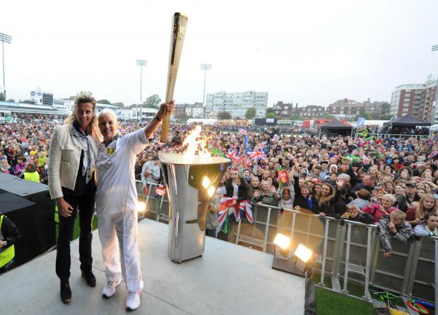 The Argus: Torch bearer Karen West with Olympian Sally Gunnell after lighting a cauldron at the Sussex Cricket Ground in Hove: credit - Simon Dack