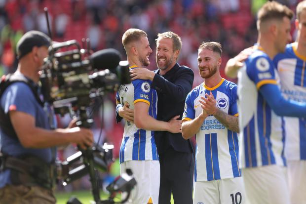 Adam Webster enjoys Brighton's win at Old Trafford with Graham Potter. Picture by Richard Parkes