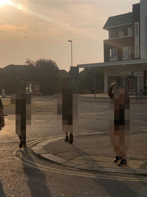The Argus: A photo taken of children leaving the co-op after allegedly shoplifting on July 19.  You can see the child on the right raising his middle finger