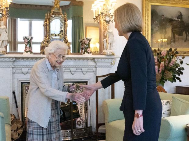 The Argus: The Queen formally invited Liz Truss to form a government earlier today: credit - PA