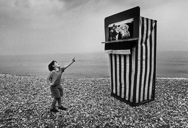 The Argus: Roger Bamber photographed on Brighton seafront by Punch and Judy in July 1992