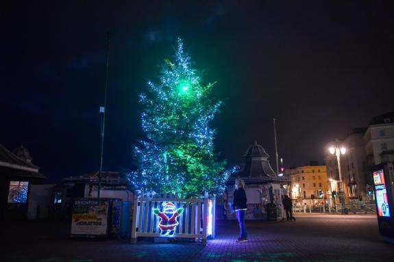 The Argus: An early morning walker enjoys the Brighton Palace Pier Christmas Tree before the sun rises on Christmas Day 2018 The Argus: An early morning walker enjoys the Brighton Palace Pier Christmas Tree before the sun rises on Christmas Day 2018