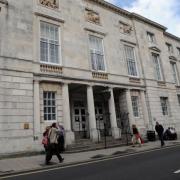 A carer defrauded an elderly man of more than £150,000, a court has decided. Pictured is Lewes Crown Court