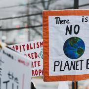 Climate change protestors hold their placards high..