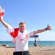 An England fan celebrates on Brighton beach in July 2021