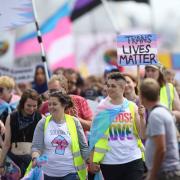 Activists wave banners at the Trans Pride Brighton march in 2018 - credit: Kate Sutton