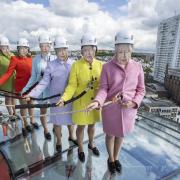 Staff at the i360 donned masks of the Queen and climbed on top of the attraction's glass pod while high above the city