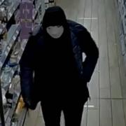 Police have released a CCTV image of a suspect in a robbery at a Co-op in Burgess Hill