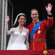 Prince William and Kate Middleton waving to the crowd from the balcony of Buckingham Palace on their wedding day. Picture: PA