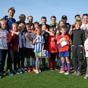 A group of Ukrainian refugees with Brighton players and coaches