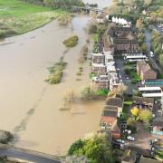 These drone pictures show the river getting close to properties at Pulborough