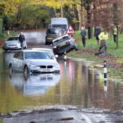 Cars became stranded across Sussex after heavy rain caused flooding on several roads