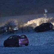 Cars in a field near Saddlescombe Road after the crash due to snow