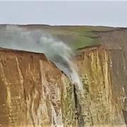 Watch: Incredible moment waterfall flows upwards as gale force winds batter coast