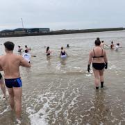 Swimmers braved cold conditions to take a dip in the sea on the morning of New Year's Day
