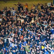 Fans celebrate Albion's win over Chelsea at Stamford Bridge