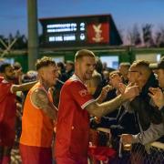 Rob O'Toole leads Whitehawk players as they celebrate with fans
