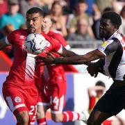 Crawley Town's Kwesi Appiah (left) and Rochdale's Jeriel Dorsett battle for the ball. Image: PA