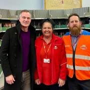 Peter Kyle with two staff members at the Hove sorting office
