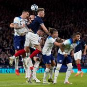 Lewis Dunk heads clear for England at Hampden Park