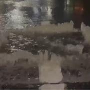 Water bursting from the manhole cover