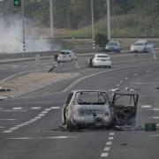 A car destroyed in an attack by Palestinian militants is seen in Sderot, Israel, on Saturday, Oct. 7, 2023. Palestinian militants in the Gaza Strip infiltrated Saturday into southern Israel and fired thousands of rockets into the country while Israel