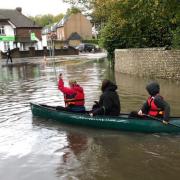 Sports students grabbed a canoe and rowed across a flooded road after yesterday's storm