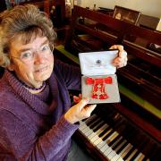 The family have of well-known musician Muriel Hart have paid tribute to her. Pictured is Ms Hart in 2005 with her MBE awarded for services to music