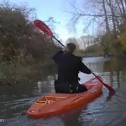 A police officer on the borrowed kayak