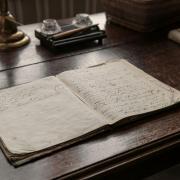 handwritten notes in a notebook in the style that the Christ's Hospital boys would write in