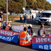 Seven Insulate Britain protesters will stand trial accused of blocking the road near Dover Port. Pictured near the port in 2021
