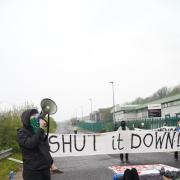 A protester using a megaphone outside L3Harris.