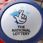 National Lottery sign outside a newsagent in north London (Yui Mok/PA)