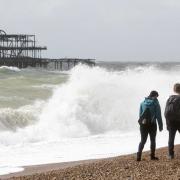 Walkers brave the autumn weather on Brighton beach