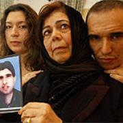 Omar's mother Zohra Zewawi, sister Amani and brother Taher with a picture of him