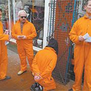 Band members dress in Guantanamo Bay-style prison suits to promote a benefit gig for Omar Deghayes