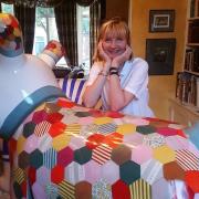Artist Judith Berrill with the two Snowdogs she designed at her home.