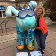 Artist Lynne Bannon is reunited with her finished Under the Sea Snowdog in position for the trail.